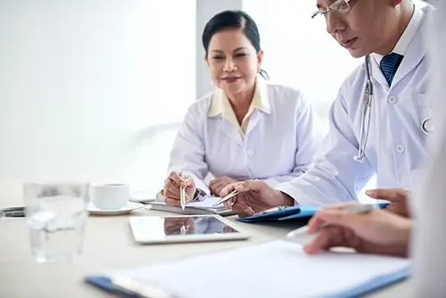 hospital workers analyzing medical data meeting